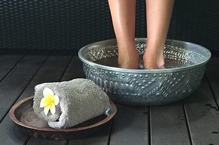 woman enjoying foot soak rolled up towel